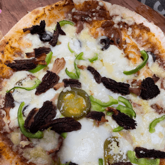 Morel mushrooms added to a pizza